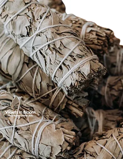 A close-up of a hand-tied white sage bundle